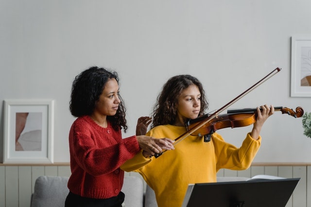 violin teacher with student